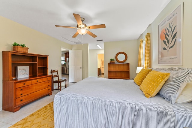 17183 76th St N, Loxahatchee, FL 33470 - bedroom featuring light tile patterned flooring, freestanding refrigerator, ensuite bath, and ceiling fan