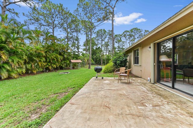 17183 76th St N, Loxahatchee, FL 33470 - view of grassy yard featuring a patio area