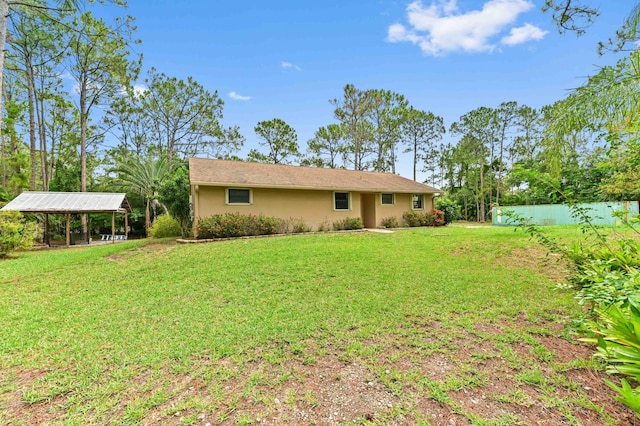 17183 76th St N, Loxahatchee, FL 33470 - rear view of house featuring a detached carport and stucco siding