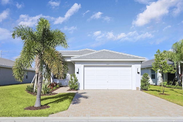 13439 SW River Rock Rd, Port Saint Lucie, FL 34987 - ranch-style house featuring a garage, decorative driveway, a front yard, stucco siding, and a tiled roof