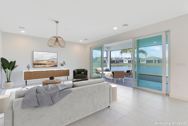 13439 SW River Rock Rd, Port Saint Lucie, FL 34987 - living area featuring recessed lighting, a water view, light tile patterned floors, and baseboards