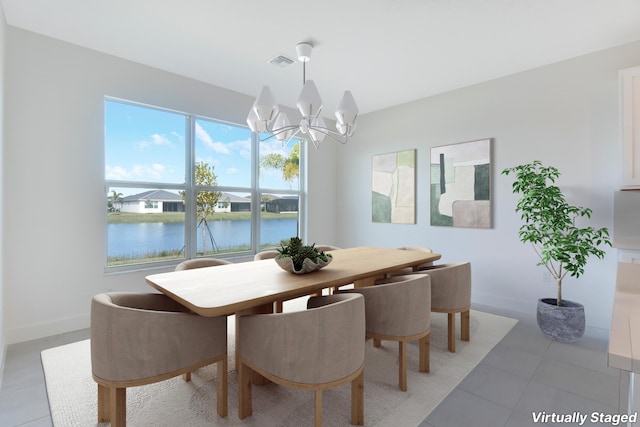 13439 SW River Rock Rd, Port Saint Lucie, FL 34987 - dining area featuring a chandelier, light tile patterned floors, a water view, and baseboards