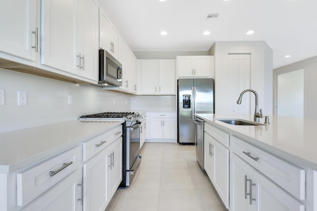 13439 SW River Rock Rd, Port Saint Lucie, FL 34987 - kitchen featuring a sink, stainless steel appliances, light countertops, white cabinets, and recessed lighting