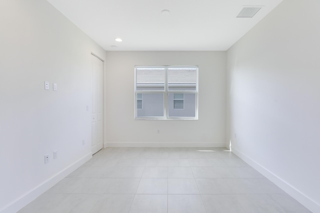 13439 SW River Rock Rd, Port Saint Lucie, FL 34987 - empty room featuring baseboards, light tile patterned floors, and recessed lighting