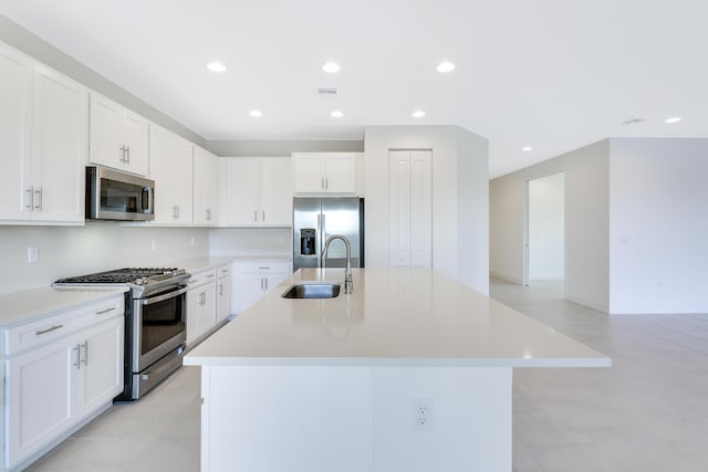 13439 SW River Rock Rd, Port Saint Lucie, FL 34987 - kitchen with stainless steel appliances, a sink, recessed lighting, light countertops, and a center island with sink