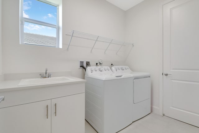 13439 SW River Rock Rd, Port Saint Lucie, FL 34987 - laundry area with washer and dryer, a sink, and light tile patterned floors