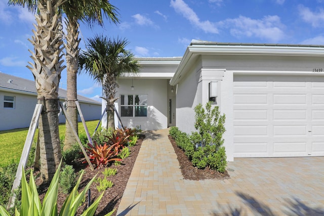 13439 SW River Rock Rd, Port Saint Lucie, FL 34987 - view of front of house featuring stucco siding and an attached garage
