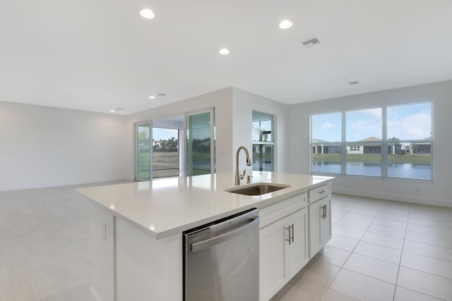 13439 SW River Rock Rd, Port Saint Lucie, FL 34987 - kitchen with dishwasher, a sink, light tile patterned flooring, a center island with sink, and open floor plan
