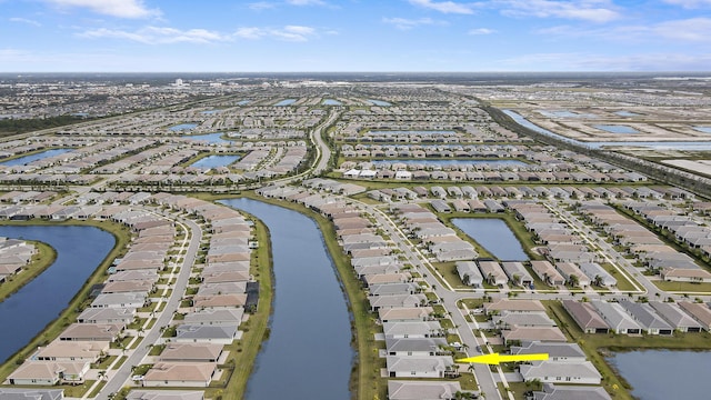 13439 SW River Rock Rd, Port Saint Lucie, FL 34987 - aerial view of property and surrounding area featuring nearby suburban area and a large body of water