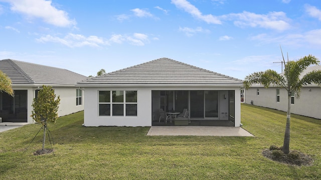 13439 SW River Rock Rd, Port Saint Lucie, FL 34987 - back of house featuring a lawn, a patio, a tiled roof, and stucco siding