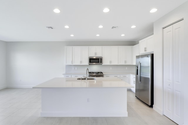 13439 SW River Rock Rd, Port Saint Lucie, FL 34987 - kitchen with stainless steel appliances, a sink, light countertops, recessed lighting, and a center island with sink