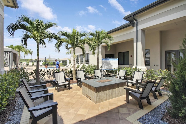 13439 SW River Rock Rd, Port Saint Lucie, FL 34987 - view of patio with an outdoor fire pit and a community pool
