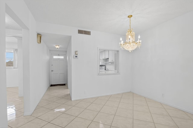 300 NE 20th St Unit 8060, Boca Raton, FL 33431 - empty room with a chandelier, light tile patterned floors, and baseboards