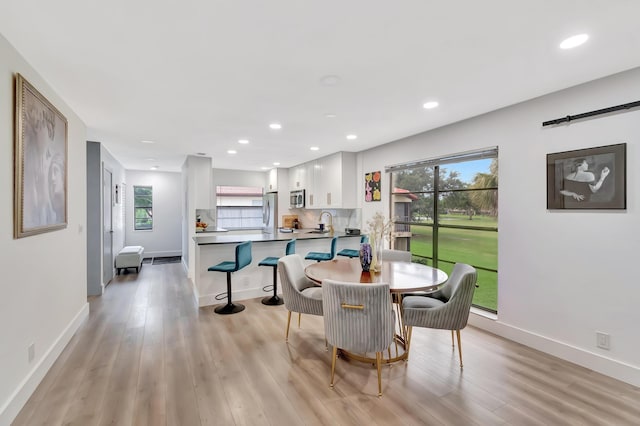 21695 Tall Palm Cir Unit 4B, Boca Raton, FL 33433 - dining space with light wood-style floors, healthy amount of natural light, recessed lighting, and baseboards