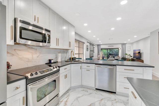 21695 Tall Palm Cir Unit 4B, Boca Raton, FL 33433 - kitchen featuring stainless steel appliances, a sink, dark countertops, light marble finish floors, and recessed lighting