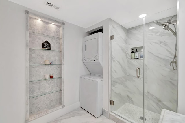 21695 Tall Palm Cir Unit 4B, Boca Raton, FL 33433 - bathroom with stacked washing machine and dryer, marble look tiles, and a marble finish shower