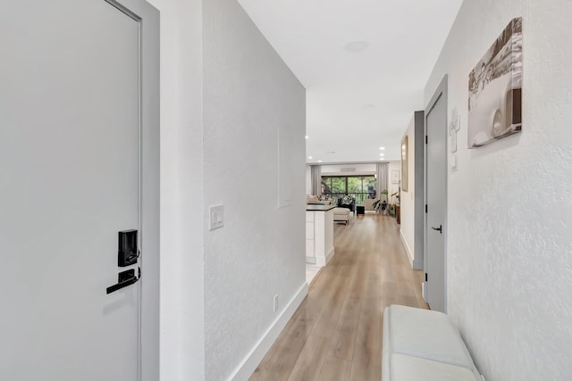 21695 Tall Palm Cir Unit 4B, Boca Raton, FL 33433 - corridor with light wood finished floors and a textured wall