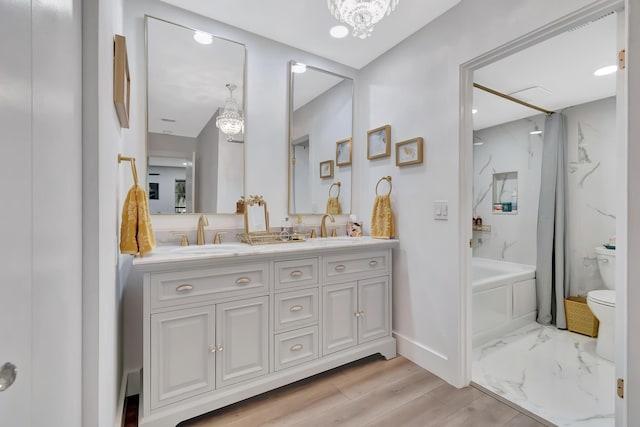 21695 Tall Palm Cir Unit 4B, Boca Raton, FL 33433 - bathroom featuring toilet, double vanity, shower / washtub combination, baseboards, and wood finished floors