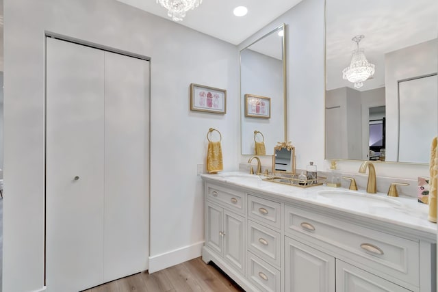 21695 Tall Palm Cir Unit 4B, Boca Raton, FL 33433 - full bath with a chandelier, double vanity, wood finished floors, and baseboards