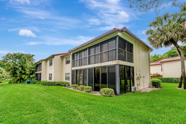 21695 Tall Palm Cir Unit 4B, Boca Raton, FL 33433 - rear view of house featuring stucco siding and a lawn