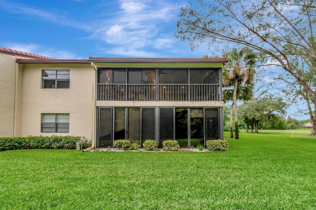 21695 Tall Palm Cir Unit 4B, Boca Raton, FL 33433 - rear view of property with stucco siding, a lawn, a tiled roof, and a sunroom