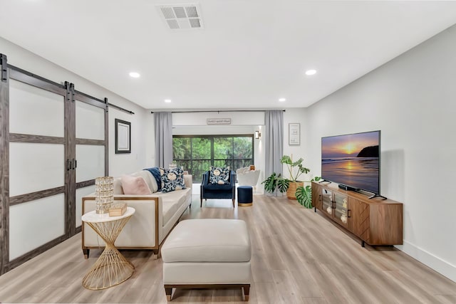 21695 Tall Palm Cir Unit 4B, Boca Raton, FL 33433 - living area with a barn door, light wood-style flooring, recessed lighting, and baseboards