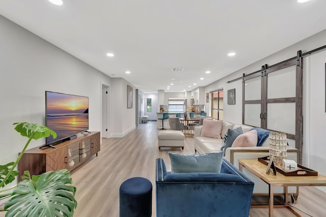 21695 Tall Palm Cir Unit 4B, Boca Raton, FL 33433 - living room with a barn door, light wood-style floors, recessed lighting, and baseboards