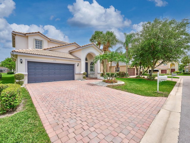 8194 Via Bolzano, Lake Worth, FL 33467 - mediterranean / spanish house featuring decorative driveway, stucco siding, a front lawn, and an attached garage