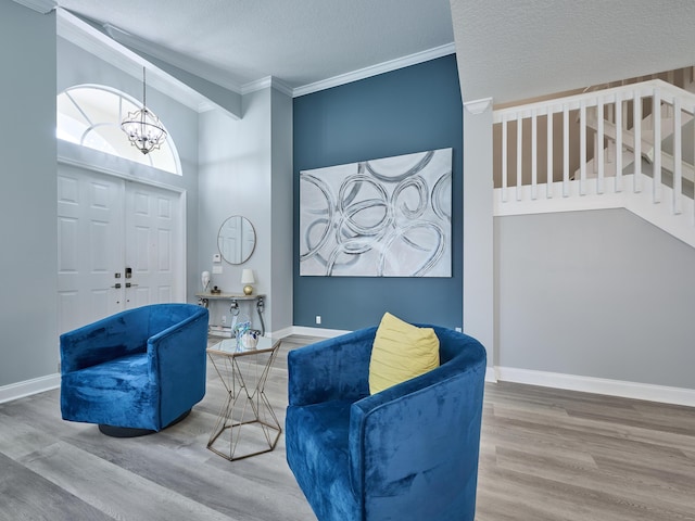 8194 Via Bolzano, Lake Worth, FL 33467 - living area with a chandelier, wood finished floors, ornamental molding, baseboards, and a textured ceiling