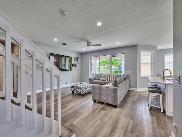 8194 Via Bolzano, Lake Worth, FL 33467 - living room with a ceiling fan, a textured ceiling, wood finished floors, baseboards, and recessed lighting