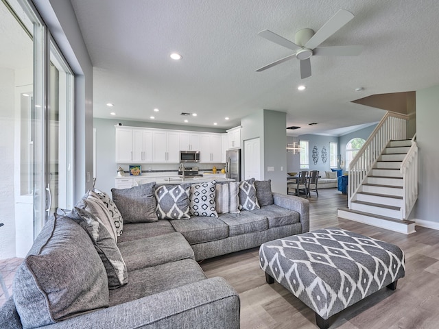 8194 Via Bolzano, Lake Worth, FL 33467 - living area featuring stairs, ceiling fan, light wood-style flooring, a textured ceiling, and recessed lighting