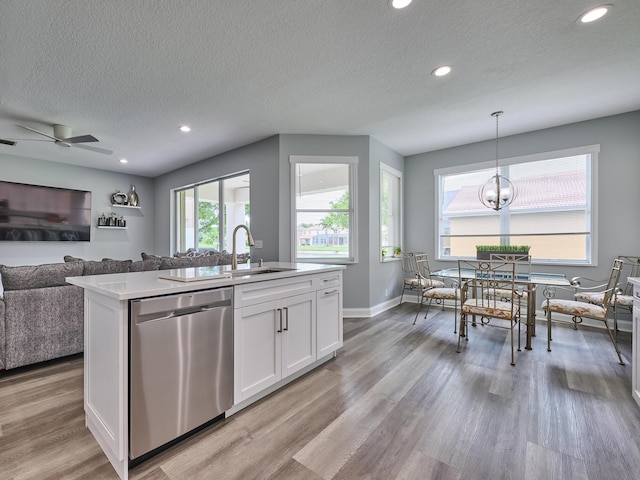 8194 Via Bolzano, Lake Worth, FL 33467 - kitchen featuring dishwasher, a sink, open floor plan, white cabinetry, and light wood-type flooring
