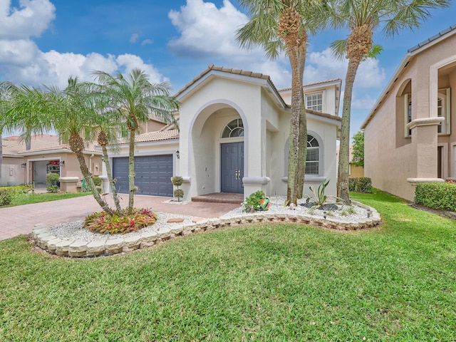 8194 Via Bolzano, Lake Worth, FL 33467 - mediterranean / spanish home featuring driveway, stucco siding, a front yard, a garage, and a tile roof
