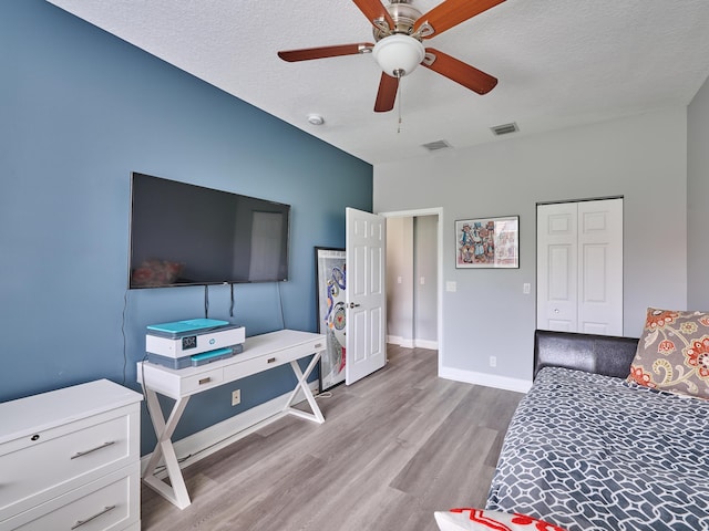8194 Via Bolzano, Lake Worth, FL 33467 - bedroom with light wood-style flooring, a textured ceiling, baseboards, ceiling fan, and a closet