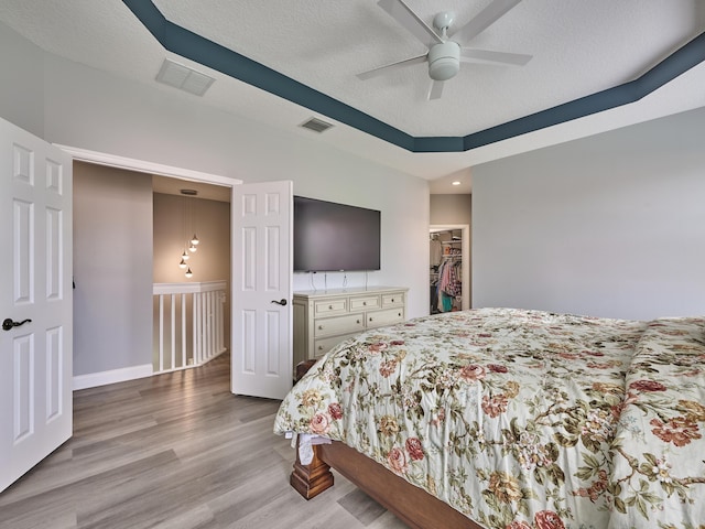 8194 Via Bolzano, Lake Worth, FL 33467 - bedroom with wood finished floors, a spacious closet, a closet, a ceiling fan, and baseboards