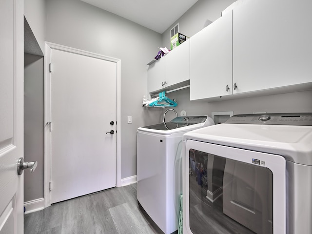 8194 Via Bolzano, Lake Worth, FL 33467 - laundry area with independent washer and dryer, cabinet space, light wood-type flooring, and baseboards