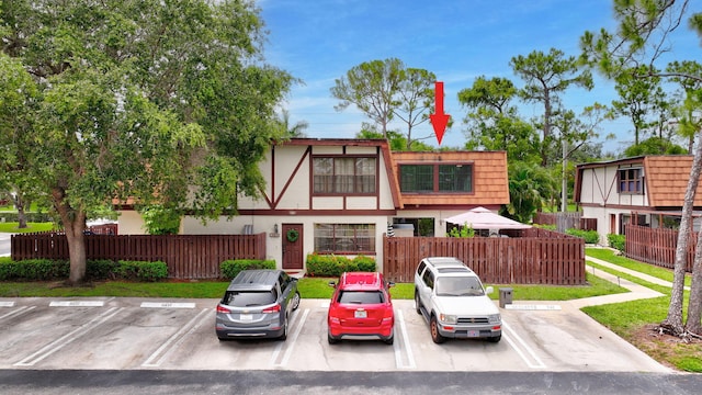 146 Weybridge Cir Unit B, Royal Palm Beach, FL 33411 - view of front of house with uncovered parking and stucco siding