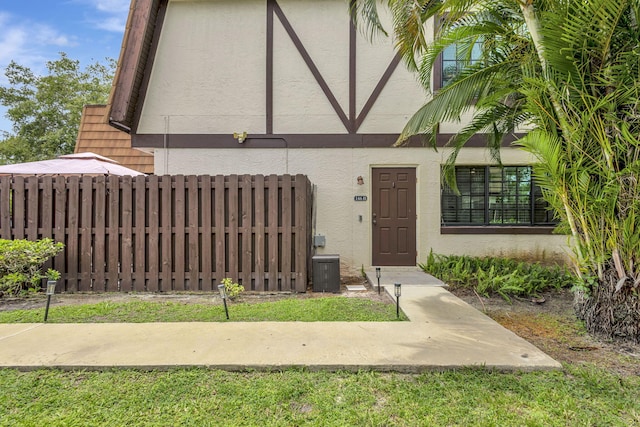 146 Weybridge Cir Unit B, Royal Palm Beach, FL 33411 - view of exterior entry featuring stucco siding
