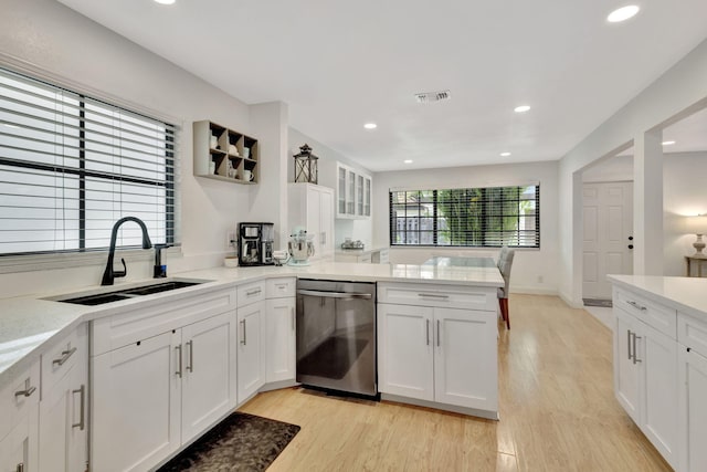 146 Weybridge Cir Unit B, Royal Palm Beach, FL 33411 - kitchen featuring dishwasher, a sink, a peninsula, white cabinets, and light countertops