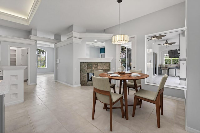 19050 SE Kokomo Ln, Jupiter, FL 33458 - dining area with a high end fireplace, ceiling fan, and light tile patterned flooring
