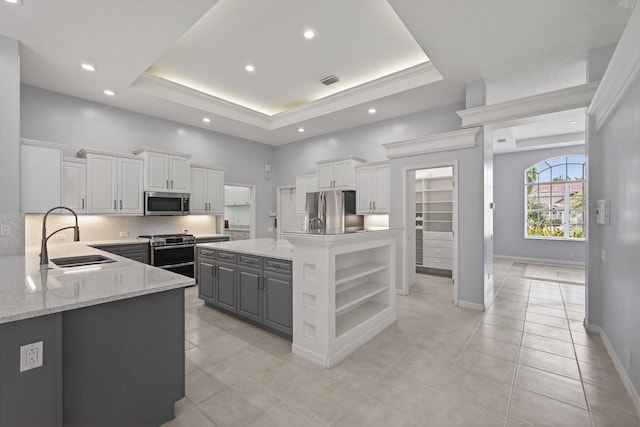 19050 SE Kokomo Ln, Jupiter, FL 33458 - kitchen featuring appliances with stainless steel finishes, open shelves, light tile patterned floors, gray cabinets, and a high ceiling