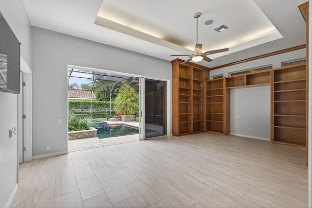 19050 SE Kokomo Ln, Jupiter, FL 33458 - unfurnished living room with a sunroom, a raised ceiling, and ceiling fan