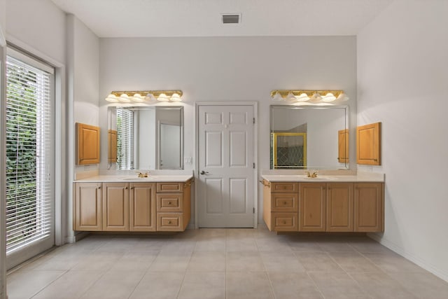 19050 SE Kokomo Ln, Jupiter, FL 33458 - full bath with a shower stall, two vanities, and tile patterned flooring