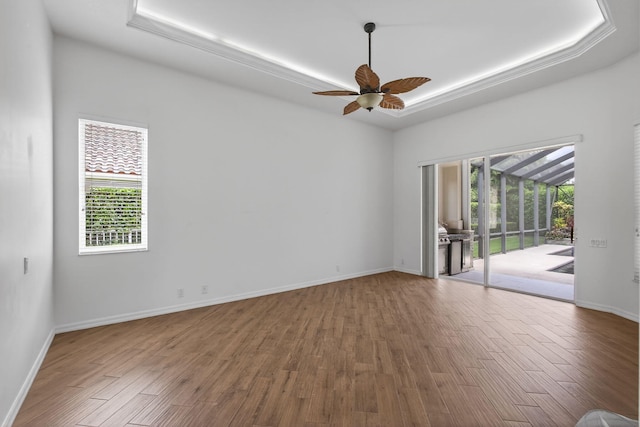 19050 SE Kokomo Ln, Jupiter, FL 33458 - spare room with wood finished floors, ceiling fan, and a raised ceiling