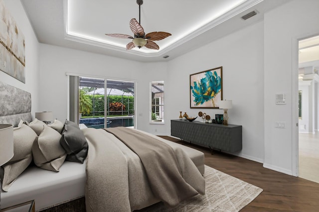 19050 SE Kokomo Ln, Jupiter, FL 33458 - bedroom featuring access to outside, a raised ceiling, wood finished floors, and ceiling fan