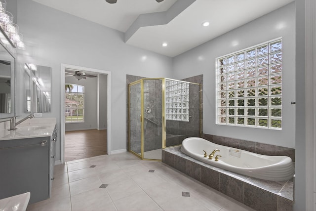 19050 SE Kokomo Ln, Jupiter, FL 33458 - full bath featuring ceiling fan, vanity, a bath, a stall shower, and tile patterned flooring