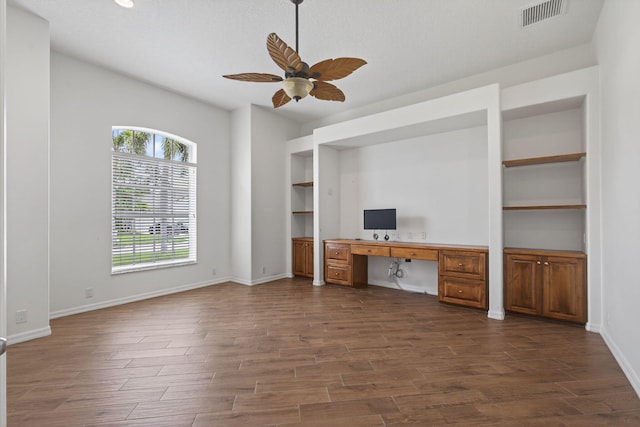 19050 SE Kokomo Ln, Jupiter, FL 33458 - unfurnished office featuring built in desk, ceiling fan, and dark wood finished floors