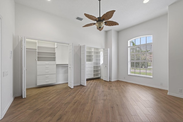 19050 SE Kokomo Ln, Jupiter, FL 33458 - unfurnished bedroom featuring wood finished floors, recessed lighting, a ceiling fan, multiple closets, and high vaulted ceiling