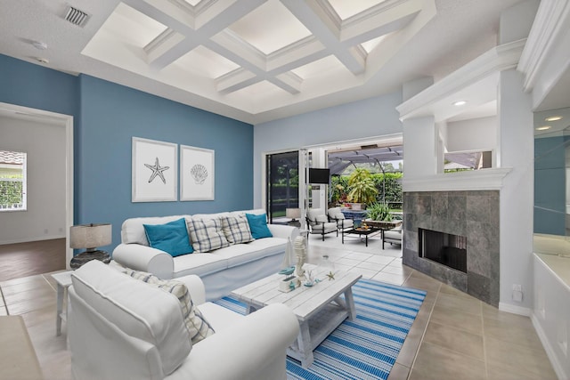 19050 SE Kokomo Ln, Jupiter, FL 33458 - living area with coffered ceiling, a tiled fireplace, beam ceiling, and tile patterned floors