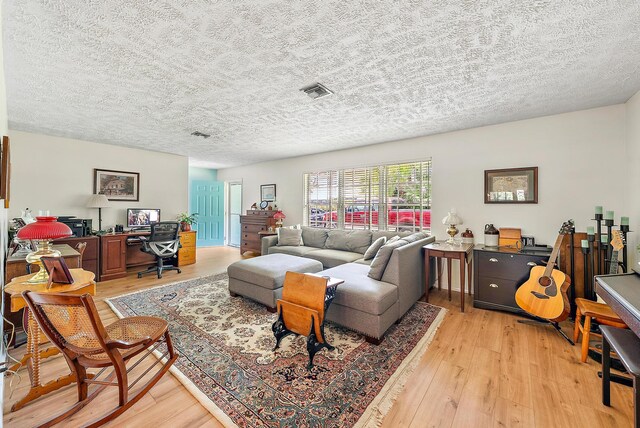 9494 SE Cove Point St, Jupiter, FL 33469 - living area with light wood-style floors, a textured ceiling, and a desk